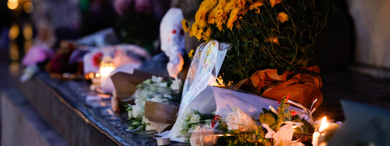 Candles and flowers at a makeshift memorial at place de la République marking 10 years since the November 13, 2015, Paris attacks.