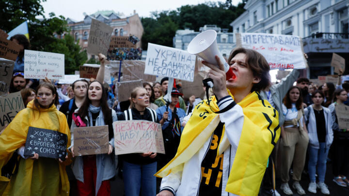 A protester uses a megaphone during a rally ahead of a vote in parliament on Thursday, in which lawmakers will consider restoring the independence of two key anti-corruption agencies.