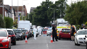 Police officers stand on duty by a cordon on Hart Street in Southport, northwest England, on July 29, 2024, following a knife attack. 