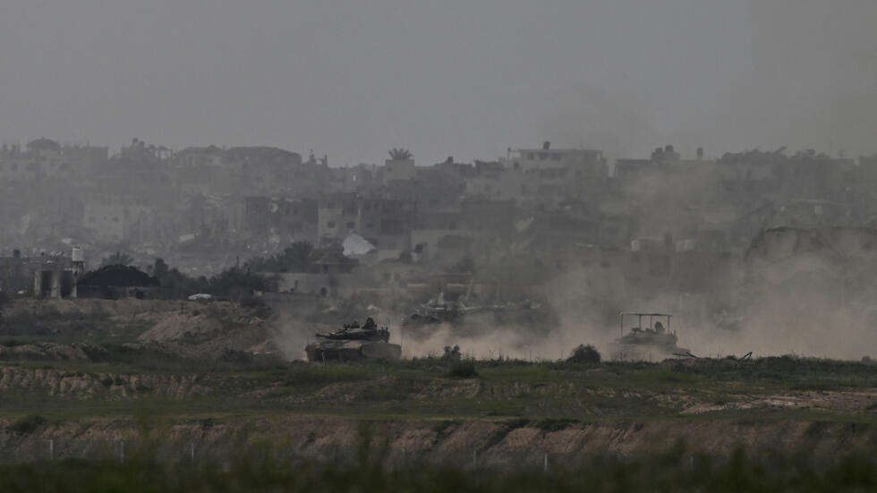 Israeli tanks manoeuvre in the Gaza Strip, near the Israel-Gaza border, amid the ongoing conflict between Israel and the Palestinian Islamist group Hamas, as seen from Israel, February 13, 2024.