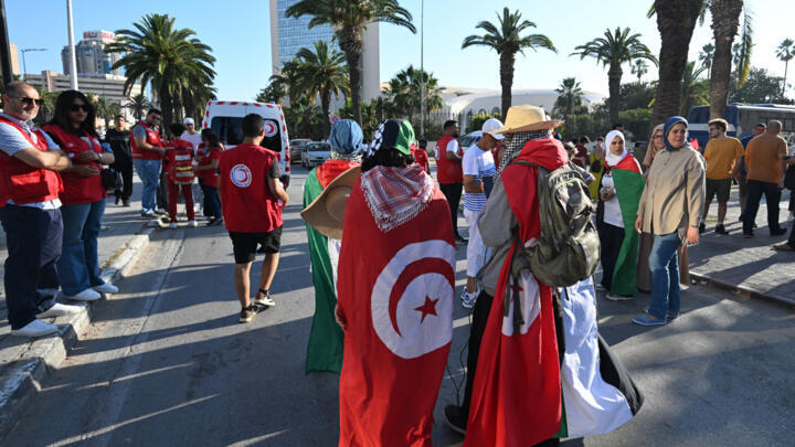 Tunisians gather at a meeting point in Tunis on June 9, 2025, ahead of the departure of a land convoy aiming to break the siege on Gaza.