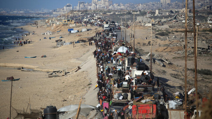 Palestinians move with their belongings southwards on a road in the Nuseirat refugee camp area in the central Gaza Strip following renewed Israeli evacuation orders for Gaza City on September 16, 2025