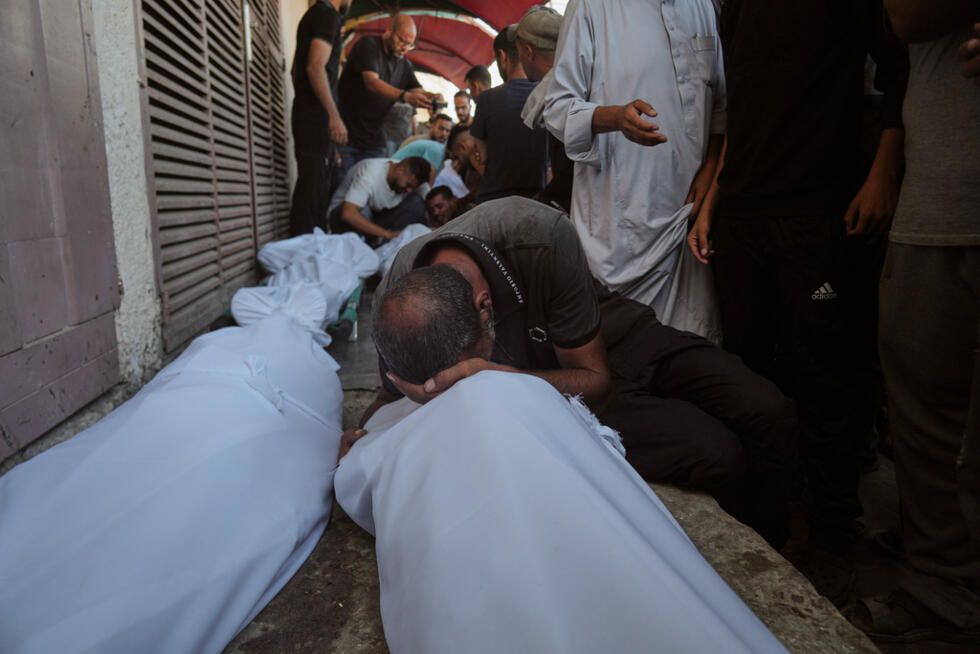 Mourners attend the funeral of Palestinians killed in an Israeli army strike, outside Al-Aqsa Hospital in Deir al-Balah, central Gaza Strip, Saturday, October 4, 2025.