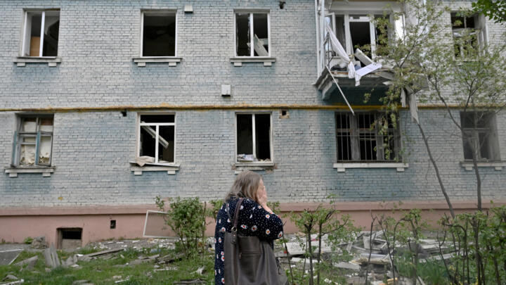 A local resident reacts in front of a damaged residential building at the site of a Russian missile attack in Kyiv on April 24, 2025, amid the Russian invasion of Ukraine.