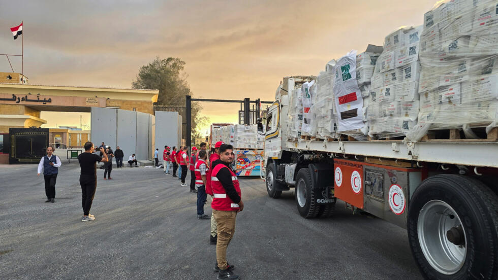 Trucks carrying aid bound for Gaza cross the border in Rafah, Egypt, on October 12, 2025.