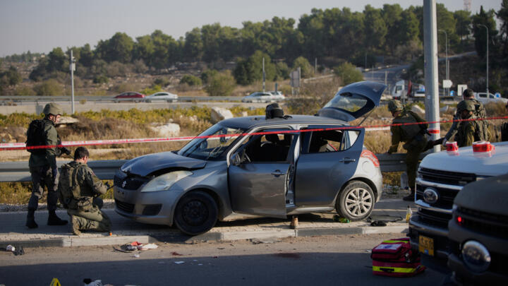 Members of Israeli security forces inspect the site of a ramming and stabbing attack near the West Bank Jewish settlement of Gush Etzion. 