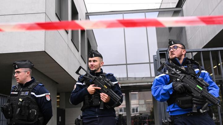 French gendarmes stands guard at the entrance of the high school Robert Schuman in Benfeld, north eastern France, on September 24, 2025 after a teacher was stabbed with a sharp weapon by a student earlier in the day.