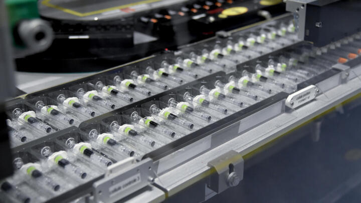 Vials on a production line at the factory of British multinational pharmaceutical company GlaxoSmithKline (GSK) in Saint-Amand-les-Eaux, northern France, on December 3, 2020, where the adjuvant for Covid-19 vaccines will be manufactured.
