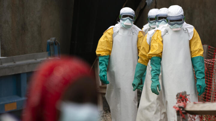 Health workers dressed in protective gear begin their shift at an Ebola treatment center in Beni, Congo DRC, Tuesday, July 16, 2019.