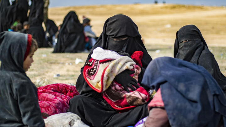 Dorothee Maquere, wife of French jihadist Jean-Michel Clain, sitting with four of her five children in Deir Ezzor province, eastern Syria, on March 5, 2019.