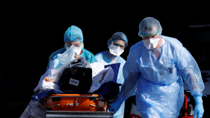 A patient infected with coronavirus is carried on a stretcher by a French rescue team before being transferred by a helicopter of the civil security (Securite Civile) from Strasbourg university hospital to Pforzheim in Germany as the spread of the coronavirus disease (COVID-19) continues, in France, March 24, 2020.  