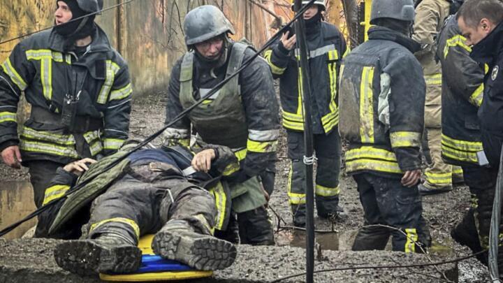 This handout photograph taken and released by Ukrainian Emergency Service on March 15, 2024 shows rescuers carrying their injured colleague following a Russian missile attack in Odesa .