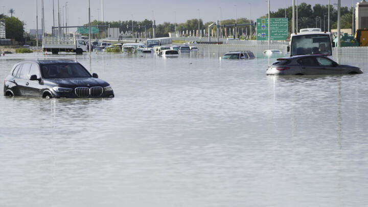 Vehicles sit abandoned in floodwater covering a major road in Dubai, United Arab Emirates, Wednesday, April 17, 2024. Heavy thunderstorms lashed the United Arab Emirates on Tuesday, dumping over a yea