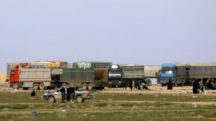 Dozens of trucks evacuate civilians from last IS group holdout in Syria