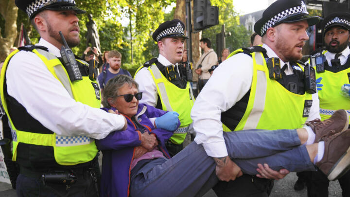 Police officers carry a protester during a Palestine Action support demonstration in London on September 6, 2025.
