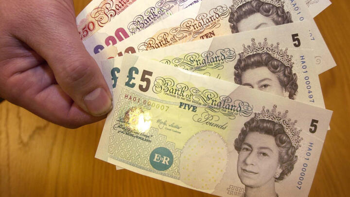 A series of bank notes are displayed in central London showing the Queen's portrait on the British Pound, January 20, 2003.