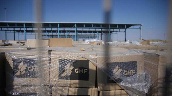Piles of humanitarian aid packages from GHF, Gaza Humanitarian Foundation, wait to be picked up on the Palestinian side of the Kerem Shalom crossing