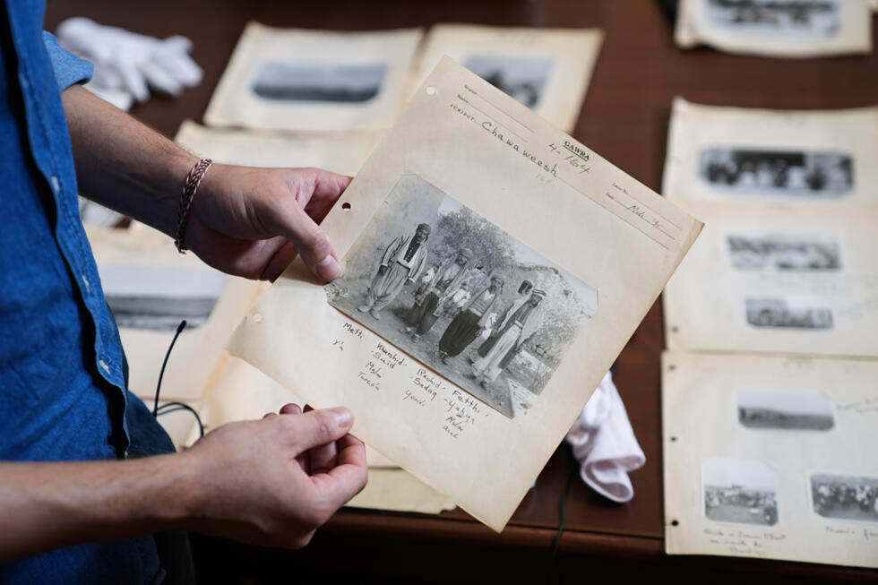 University of Pennsylvania doctoral student Marc Marin Webb displays an image from a collection of photos of the Yazidi people in their northern Iraq homeland in the 1930s.