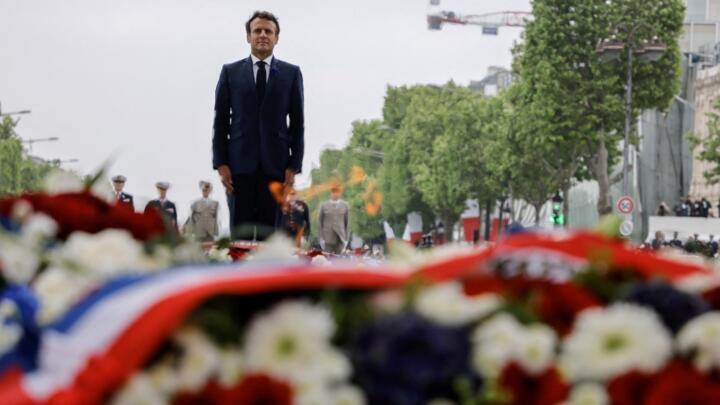 French President Emmanuel Macron stands in front of the tomb of the unknown warrior at the Arc de Triomphe, May 8, 2022.