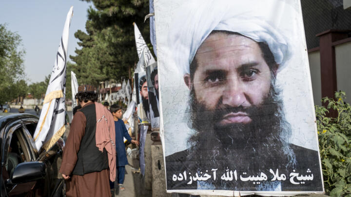 A poster of Taliban Supreme Leader Hibatullah Akhundzada is seen along a road in Kabul on August 14, 2023.