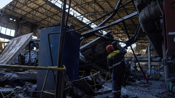 Workers walk among debris in a damaged DTEK thermal power plant after a Russian attack in Ukraine, Thursday, May 2, 2024.