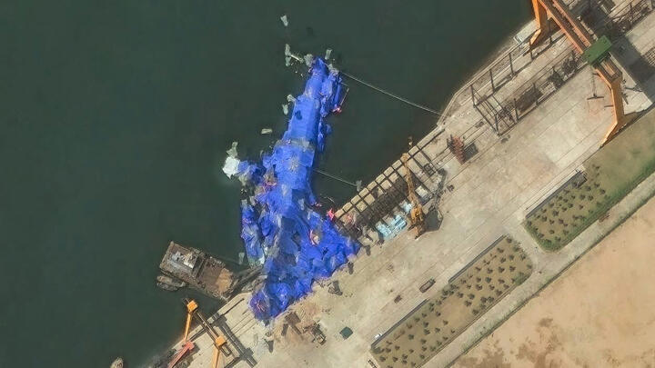 This handout satellite image courtesy of Maxar Technologies taken on May 23, 2025, shows a general view of a new North Korean warship at the harbor after its launch accident in Chongjin.
