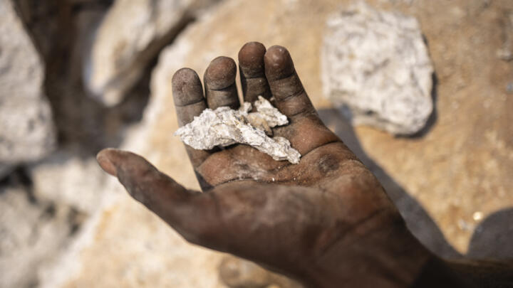 Miners hold stones that contains lithium in a mining site in Gidan Kwano, in Nasarawa state, on January 23, 2025. 