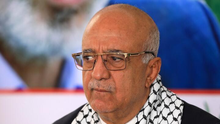 Prime Minister Ahmed al-Rahawi (left) of Yemen's Houthi-led government speaks during a visit to the Hamas offices in Sanaa on October 20, 2024.