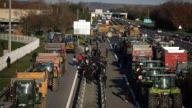 Farmers block part of the A64 motorway, during a demonstration in Carbonne, south-western France, on December 12, 2025
