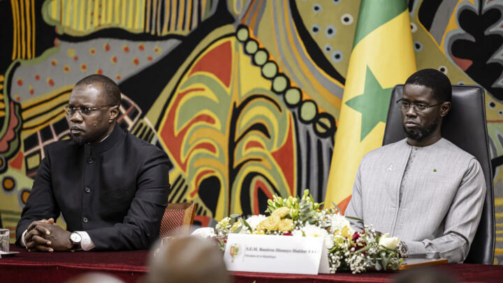 Senegal PM Ousmane Sonko (L), Senegal President Bassirou Diomaye Faye attend a ceremony after receiving the official report on the Thiaroye massacre, at the Presidential Palace in Dakar, Oct. 16, 2025