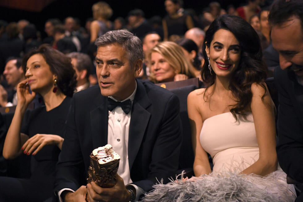 Actor George Clooney, who admits his French is 'bad', and wife Amal Clooney, who is fluent
