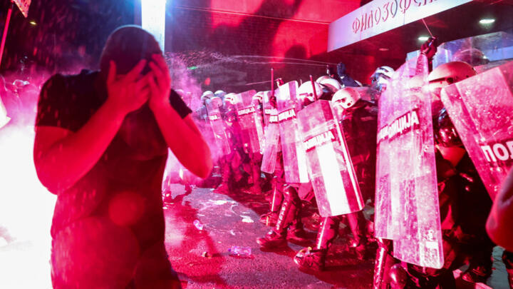 Riot police officers use pepper spray, while clashing with anti-government protestors, during a protest against what the demonstrators say is an increase in police brutality, at the university campus,