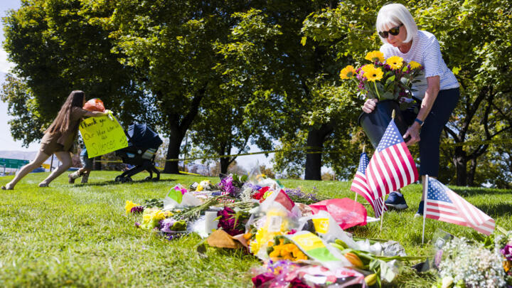 Karen Thompson places flowers at a makeshift vigil for political activist Charlie Kirk at Utah Valley University on September 11, 2025 in Orem, Utah.