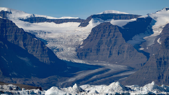 This photograph taken in Scoresby Fjord, eastern Greenland, shows a partly melted glacier.