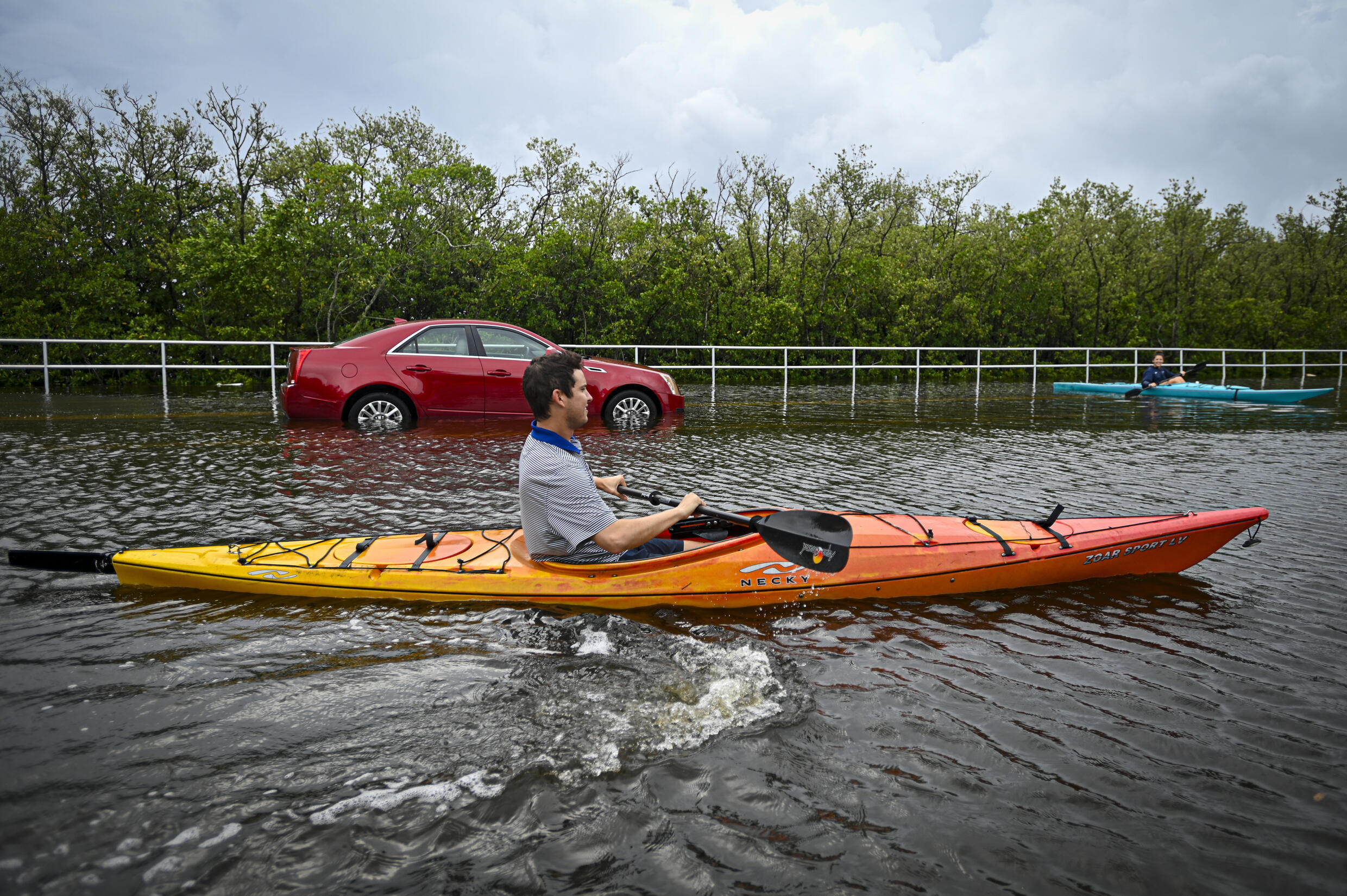 Residents use kayaks to travel on a flooded road in Tampa, Florida, on August 30, 2023, after Hurricane Idalia made landfall