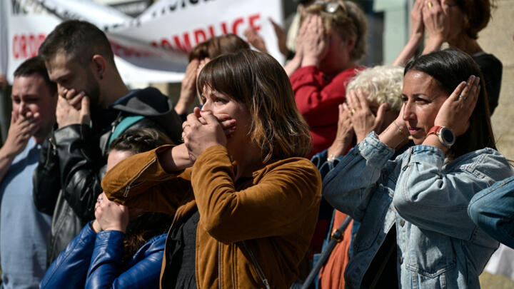 Protestors react during a demonstration in support of the victims of former surgeon Joel Le Scouarnec outside the court in Vannes, western France on May 19, 2025.