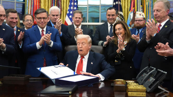 President Donald Trump signs the funding bill to reopen the government, in the Oval Office of the White House, Wednesday, Nov. 12, 2025, in Washington.