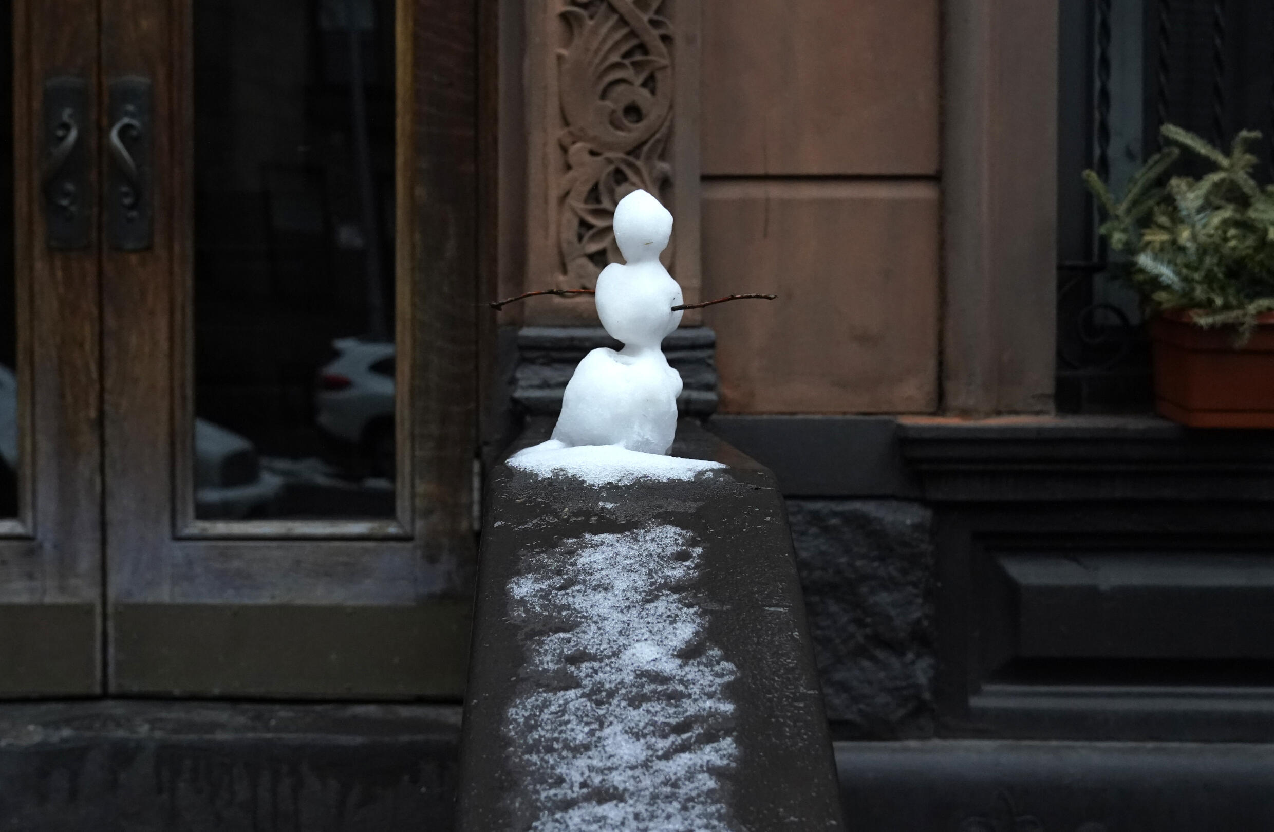Un pequeño muñeco de nieve en un pórtico del West Side de Nueva York, el 28 de febrero de 2023