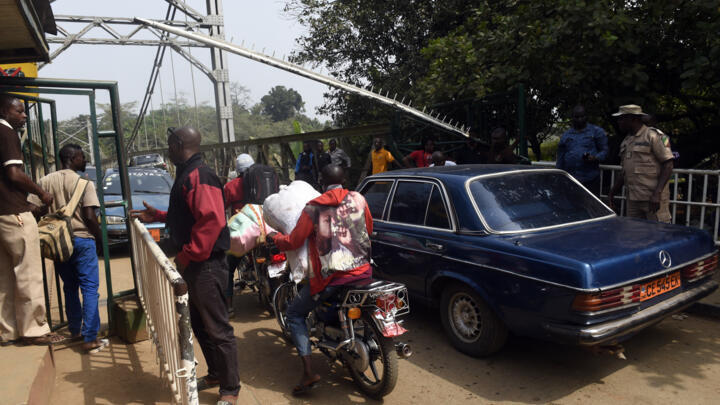 Security guards check vehicles leaving Nigeria for Cameroon at a checkpoint border between Cameroon and Nigeria in southeast Nigeria on February 1, 2018.