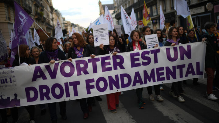 Demonstrators march behind a banner reading, 'Abortion is a fundamental right' at a rally in Paris on International Safe Abortion Day on September 28, 2022. 