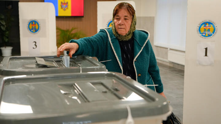 A woman casts her vote during a parliamentary election, in Chisinau, Moldova, Sunday, Sept. 28, 2025.