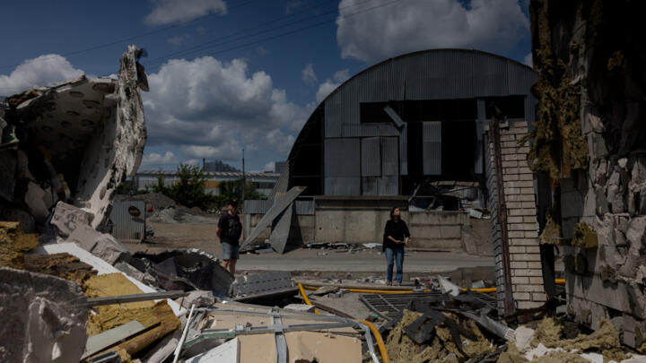 People look at a damaged building following Russian drone strikes on Ukraine's capital Kyiv on June 10, 2025, amid the Russian invasion in Ukraine.