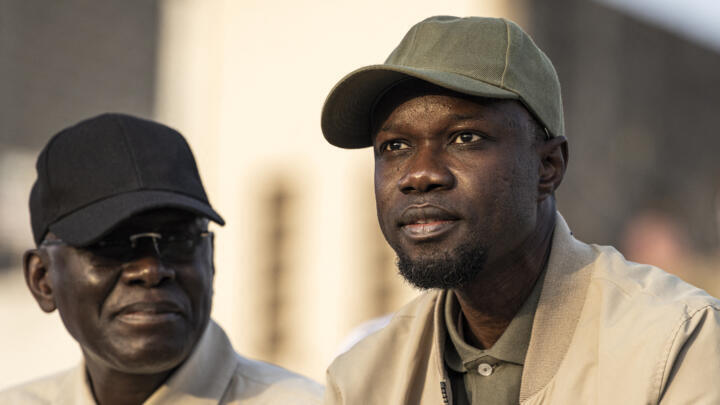 Protesters sit on top of sandbag barricades as they block the road to opposition leader Ousmane Sonkos house in Ziguinchor, Senegal on May 22, 2023. Protesters have been blocking the roads in Ziguinchor to stop the arrest of opposition leader Ousmane Sonko ahead of his rape trail, which should start on May 24, 2023. (Photo by MUHAMADOU BITTAYE / AFP)