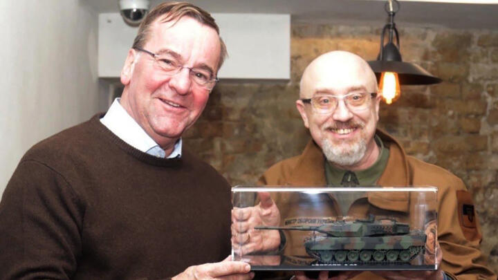 Handout image taken from the Twitter account of Ukrainian Defence Minister Oleksiy Reznikov on February 7, 2023, shows him with his German counterpart Boris Pistorius (L) in Kyiv with a Leopard-2 tanks model.