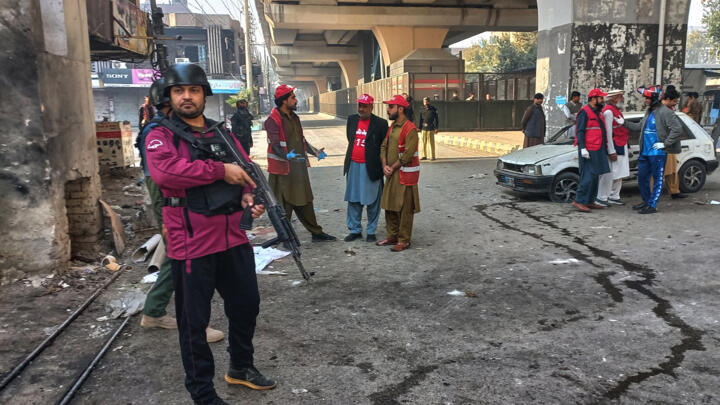Security officials gather at the the gate of the Federal Constabulary (FC) headquarters in Peshawar, Pakistan, November 24, 2025.