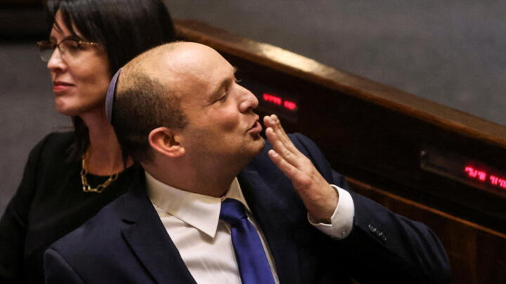 Israel's new Prime Minister Naftali Bennett gestures at the Knesset, Israel's parliament, during a special session in which his new coalition government was sworn in, June 13, 2021.