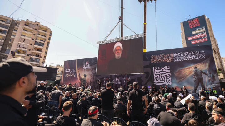 Lebanese Shiite Hezbollah supporters listen to a televised speech by the movemen't leader Naim Qassem, in Beirut's southern suburbs on July 6, 2025.