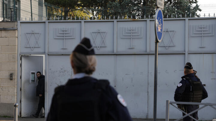 French police officers stand guard in front of a synagogue in the Parisian suburb of Sarcelles, on October 11, 2023.