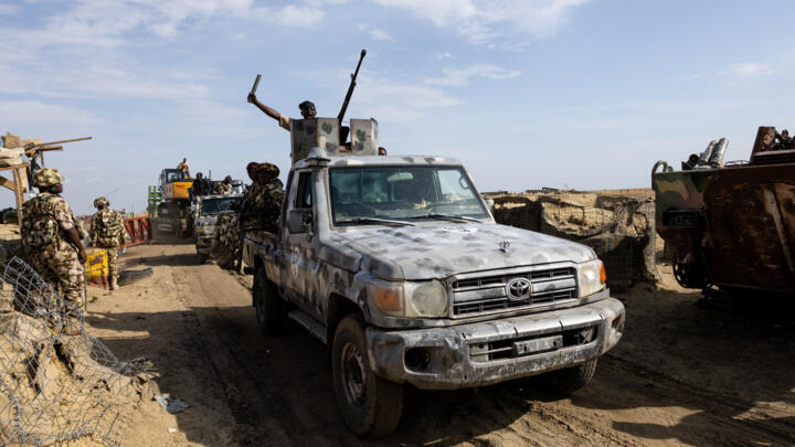 A military escort passes through a checkpoint at the entrance to Monguno, Borno state, Nigeria on July 4, 2025. 