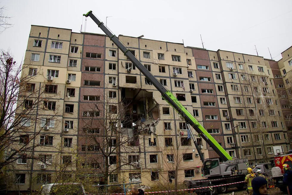 Ukrainian rescuers work at the site of a heavily damaged residential building following an air attack in Dnipro.